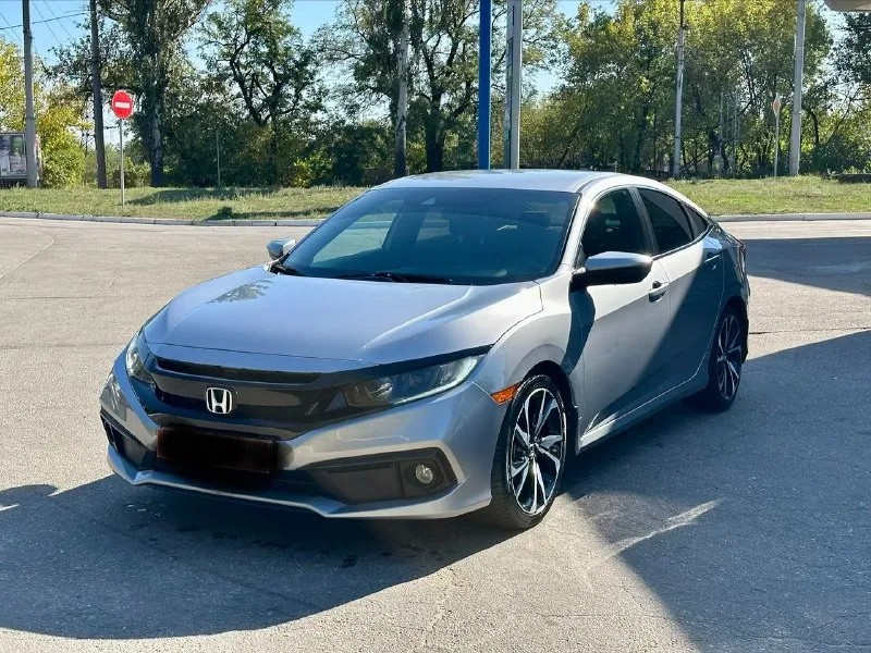 Продается honda civic 2.0 sport (2019), идеальное состояние цена 1🍋980 тыс. руб, торг. год выпуска: 2019 пробег: 60 000 км (оригинальный) двигатель: 2.0 л, атмосферный трансмиссия: вариатор привод: передний расход топлива: 7-8 л/100 км honda civic 2.0 sport 2019 года выпуска в безупречном состоянии. автомобиль был лично пригнан из сша в 2021 году и эксплуатировался бережно, преимущественно в летний период. хранился на обогреваемом паркинге. оригинальный пробег составляет всего 60 000 км, что подтверждается отличным техническим состоянием. преимущества: * надежный двигатель: атмосферный двигатель 2.0 известен своим ресурсом более 500 000 км и обеспечивает оптимальный баланс экономичности и динамики. регулярное обслуживание с заменой масла каждые 6 000 км гарантирует его долговечную работу. * идеальное состояние кузова: автомобиль не имеет повреждений и находится в отличном внешнем виде. * комплектация sport: спортивный обвес, 18-дюймовые литые диски и спортивная подвеска 📞 звоните: +7(949)3121414 - фотография - 3