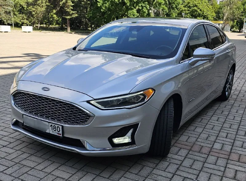 Ford fusion hybrid 2019, топовая комплектация titanium. пробег 99 800 км. я единственный владелец в рф. история чистая, птс оригинал, без подводных камней! 🔥 гибрид! реальный расход 5-6 л/100 км, полного бака хватает на 900 км. тихий, комфортный, управляется отлично. ✅ адаптивный круиз, автоторможение, удержание в полосе, слепые зоны ✅ камера заднего вида, парктроники, биled фары ✅ кожаный салон, сиденья с памятью, подогревом и вентиляцией ✅ подогрев руля, 2-зонный климат ✅ аудио sony (12 динамиков), навигация ✅ автозапуск, шайба-джойстик кпп ✅ бесключевой доступ, в т. ч. кодовый ✅❗ европейские зеркала — с широким обзором и складыванием 📌 пробег оригинальный, не скручен! 📌 любая проверка/сто 🚗 продаю без спешки, авто радует. только прямому покупателю, без посредников. 💬 1 890 000 ₽. +79494710689 - фотография - 2