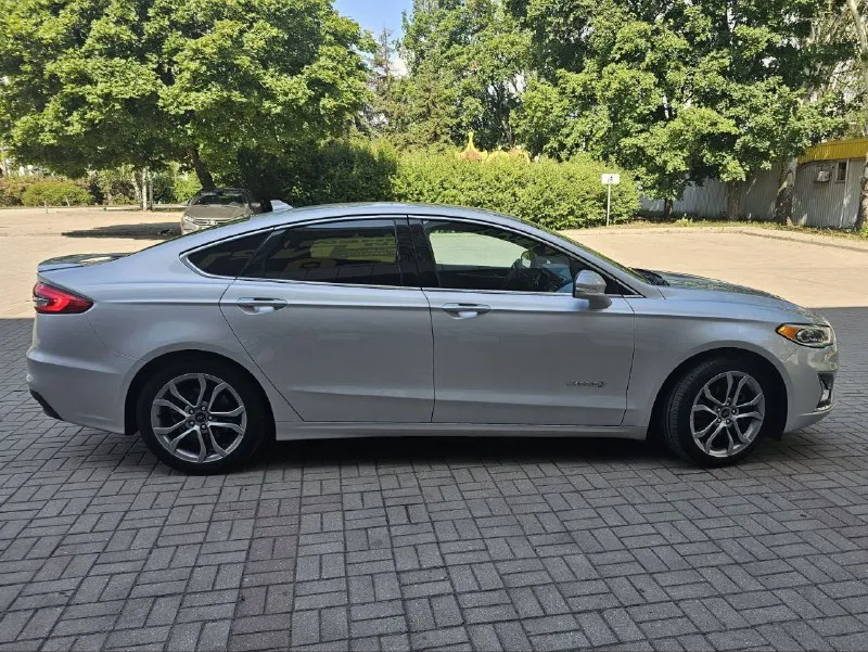 Ford fusion hybrid 2019, топовая комплектация titanium. пробег 99 800 км. я единственный владелец в рф. история чистая, птс оригинал, без подводных камней! 🔥 гибрид! реальный расход 5-6 л/100 км, полного бака хватает на 900 км. тихий, комфортный, управляется отлично. ✅ адаптивный круиз, автоторможение, удержание в полосе, слепые зоны ✅ камера заднего вида, парктроники, биled фары ✅ кожаный салон, сиденья с памятью, подогревом и вентиляцией ✅ подогрев руля, 2-зонный климат ✅ аудио sony (12 динамиков), навигация ✅ автозапуск, шайба-джойстик кпп ✅ бесключевой доступ, в т. ч. кодовый ✅❗ европейские зеркала — с широким обзором и складыванием 📌 пробег оригинальный, не скручен! 📌 любая проверка/сто 🚗 продаю без спешки, авто радует. только прямому покупателю, без посредников. 💬 1 890 000 ₽. +79494710689 - фотография - 5