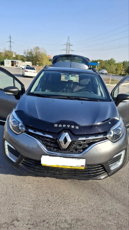 Продаётся renault kaptur 1.6 cvt 2021 — надёжный и комфортный кроссовер! пробег 41 500 км, один владелец, эптс, всё обслуживание у официального дилера. комплектация style с мультимедиа, сенсорным экраном, подогревом сидений и климат-контролем. двигатель 1.6 л, 114 л. с., вариатор x-tronic — плавная езда в городе и на трассе. машина в заводской окраске без повреждений, свежая замена масла на 33 600 км. в подарок зимние колеса на дисках и рейлинги. автомобиль в отличном состоянии, вложений не требует — сел и поехал. обмен не интересует, перекупам просьба не беспокоить. идеальный вариант для тех, кто ищет ухоженный, экономичный и практичный кроссовер. просмотр в ростове-на-дону. +79197106474 - фотография - 3