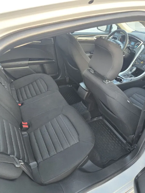 В продаже форд мондео. 2015 год, объем 2.5. пробег 117 000 родной. коробка обычный автомат. за всё время два собственника. машина в отличном состоянии, без вложений. кузов в родном окрасе. комплектация: - круиз - климат - обогрев заднего и лобового стекла - обогрев сидений - датчик давления шин - электро ручник - 4 электросклоподъемника в машине работает каждая кнопка. готов на любые проверки на вашем сто. более подробная информация по телефону. свежая диагностическая карта цена 1 250 000 тел +79495058416 - фотография - 7